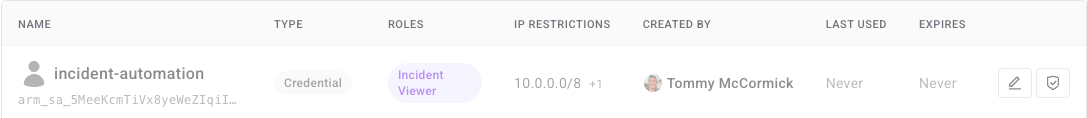 A disabled service account row in the Service Accounts table on Settings > Team, showing reduced opacity, the Status column reading Disabled, and the Disable button replaced by an Enable button
